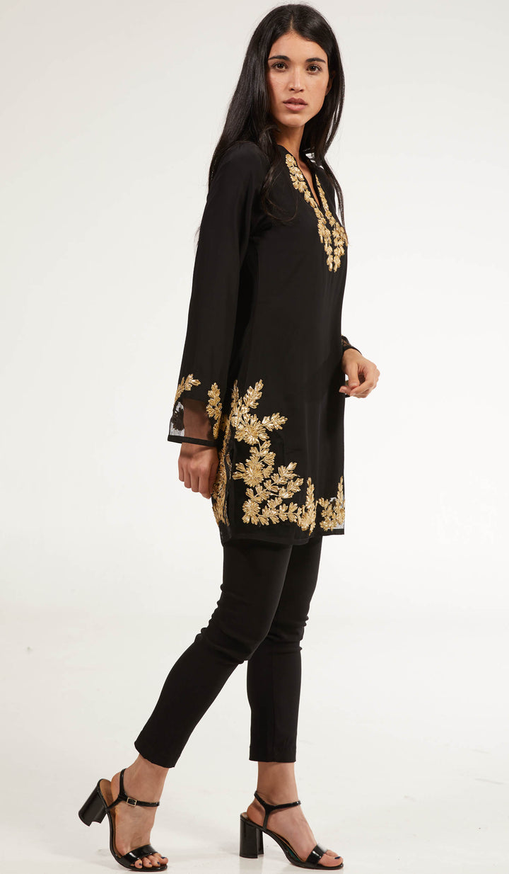 Side view of woman wearing modest Mahnaz Gold Embellished Tunic in Black.