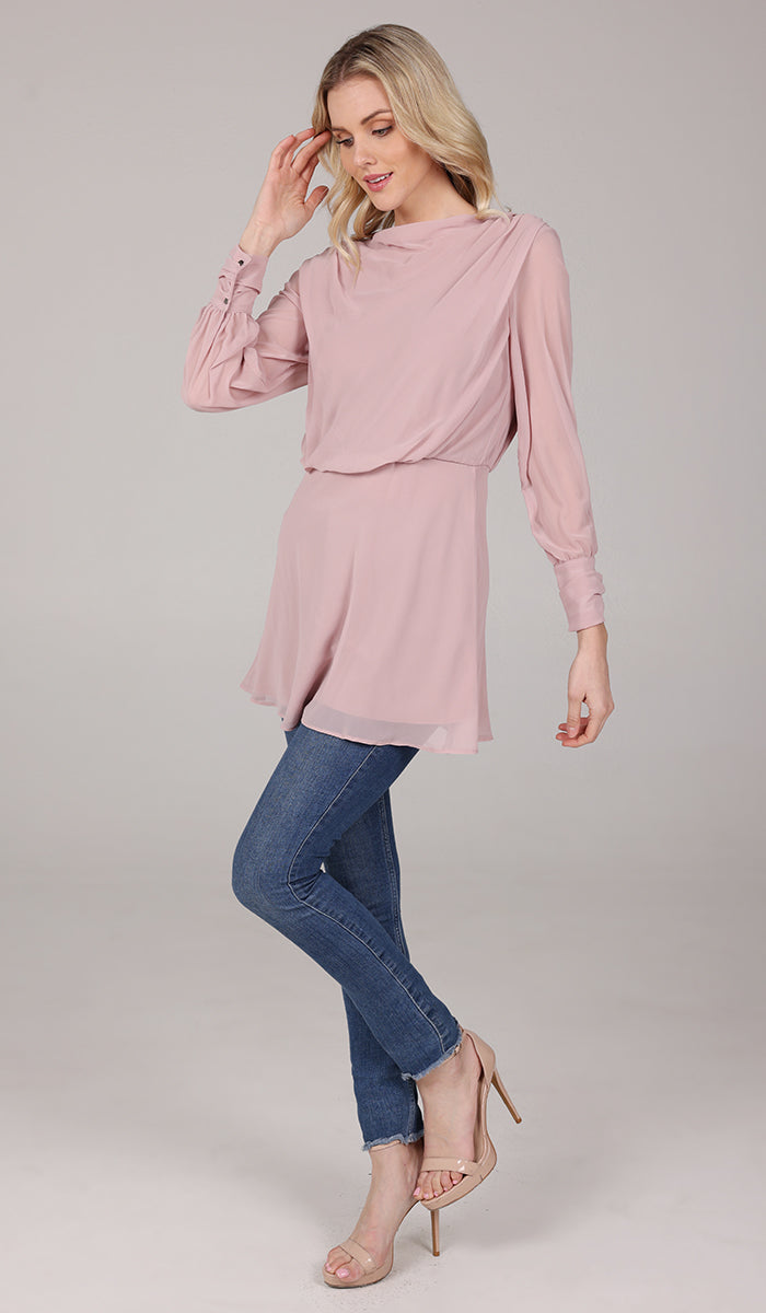 Side view of woman wearing modest Myra tunic in Tearose with jeans and heels. 