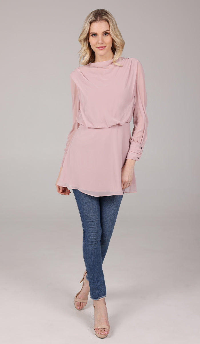 Smiling woman wearing Myra tunic in Tearose with jeans and heels. 