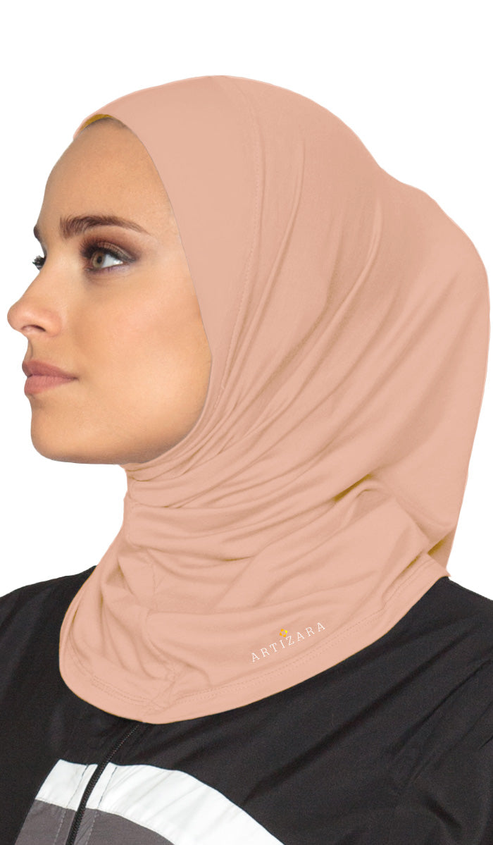 Side view of woman wearing sports hijab in Blush.