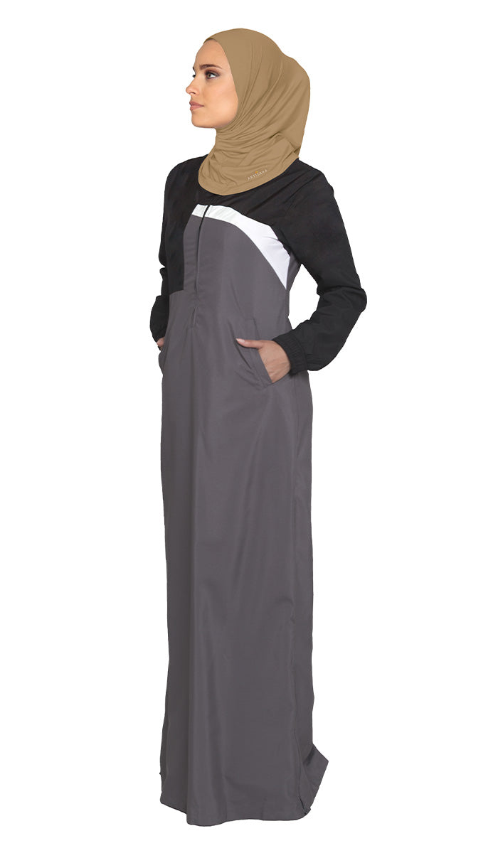 Woman wearing sports hijab in Cafe with gray dress.