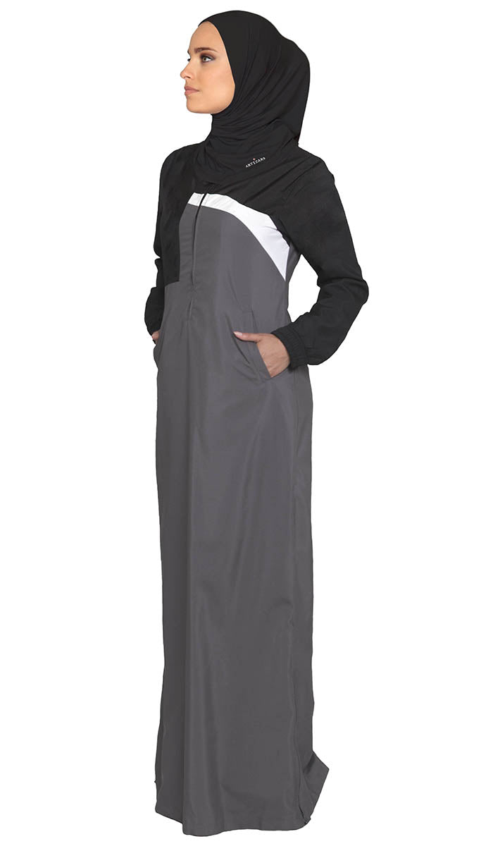 Full body view of woman wearing sports hijab in Black with grey dress.