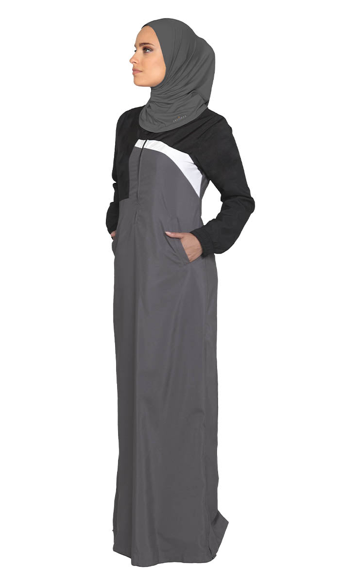 Woman wearing sports hijab in Charcoal Grey with grey dress. 