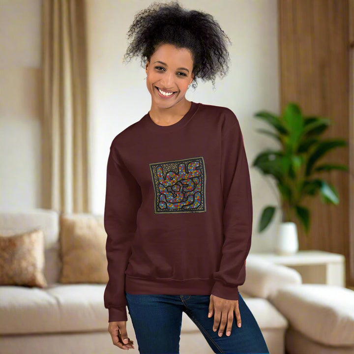 a woman wearing a maroon sweater with a square design.