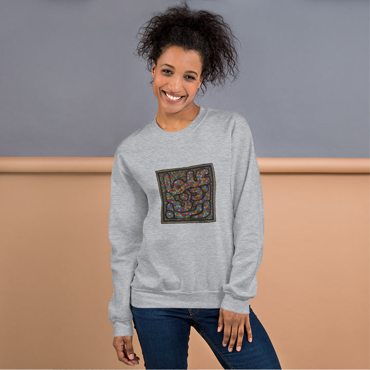 a woman wearing a gray sweater with a square design.